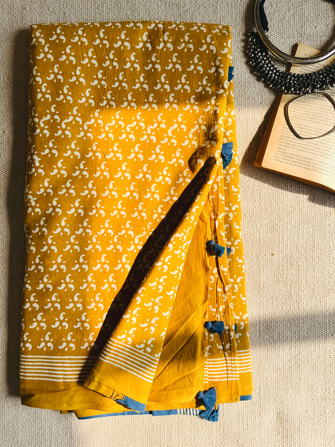 MUSTARD BLOCK PRINTED TASSELED MULMUL SAREE