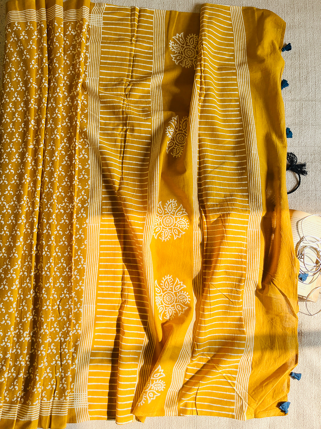 MUSTARD BLOCK PRINTED TASSELED MULMUL SAREE